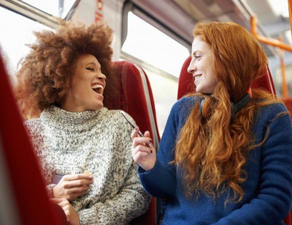 Two women talking on a train