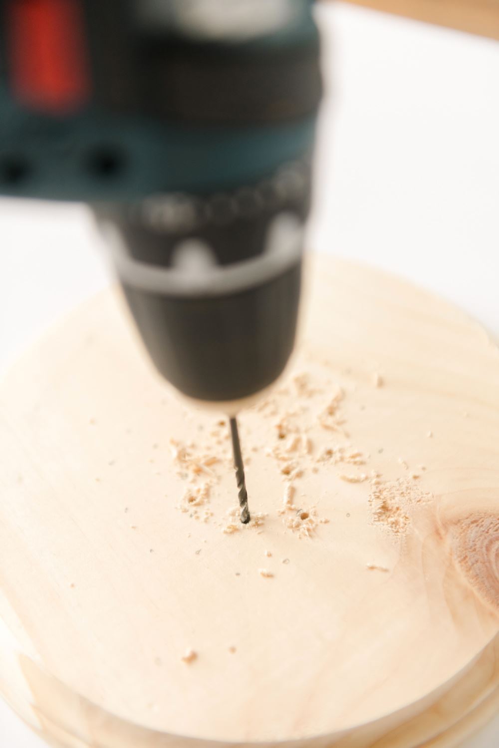 Drill holes into wooden round